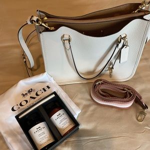 This season Coach bag! Beautiful leather, two straps & cleaner.